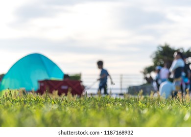 Boys and families are tent camping on a holiday with family on a bright blue day in the summer. selected focus. - Powered by Shutterstock