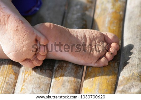 The Boys Feet Are Full Of Dust After Running In The Garden The Boys Feet Are Full Of Dust After Running In The Garden
