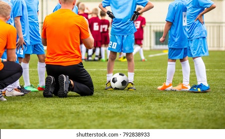 Boys With Football Coach Having Pep Talk Before Youth Sports Tournament Competition