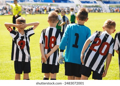 Boys in Football Team. Children Play Match in Soccer League. Friends Have Fun Playing Outdoor Football Tournament. School Sports Team Members in Black and White Soccer Jersey Shirts With Red Numbers - Powered by Shutterstock