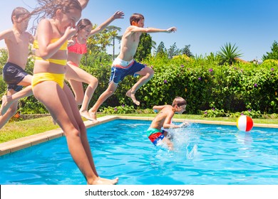 Boys and girls in a group jump in water pool outside during summer vacation - Powered by Shutterstock