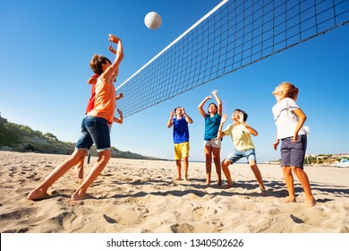 Boys And Girls Playing Volleyball On The Beach