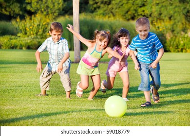 Boys and girls running towards ball