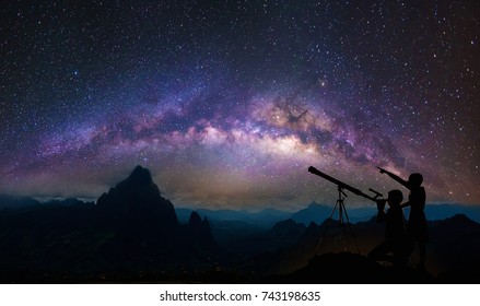 Boys and girls telescopic. Milky Way galaxy, on high mountain Long exposure photograph, with grain.Image contain certain grain or noise and soft focus.