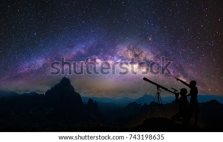 Boys and girls telescopic. Milky Way galaxy, on high mountain Long exposure photograph, with grain.Image contain certain grain or noise and soft focus.
