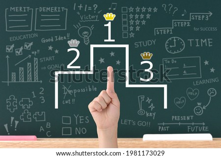 Boy's hand and podium with number and crown in front of black board Stock photo © 