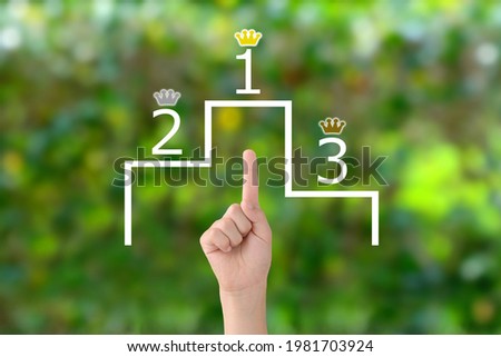 Boy's hand and podium with number and crown in front of lightning green background Stock photo © 