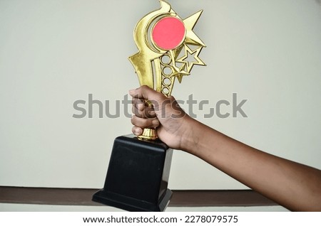 boy's hands like holding a winning trophy
