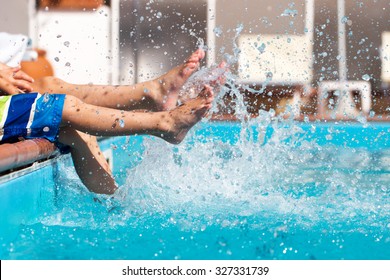 Boys legs splashing water in pool, summer holiday - Powered by Shutterstock