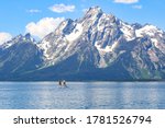 Boys paddle boarding on Jackson Lake in Grand Teton National Park, Wyoming, USA