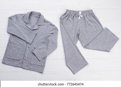 Boys' pajama set on white. Soft gray melange cotton. Loose-fitting shirt and pants for comfort rest at night.