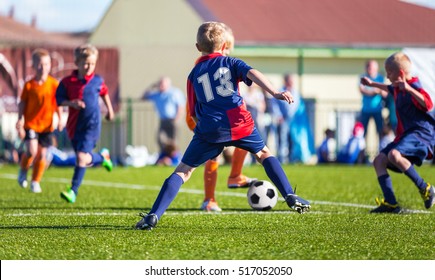 Boys Play Football; Children kicking Soccer Ball; Football Tournament for Youth Sports Teams