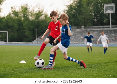 Boys playing football game on a school tournament. Football soccer match for children. Dynamic, action picture of kids competition during playing football - Powered by Shutterstock