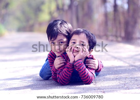 Similar – Two children laughing while playing in the playground.