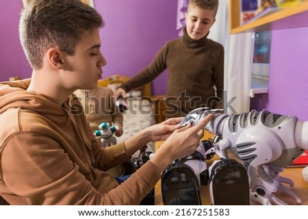 boys playing with robots in their room