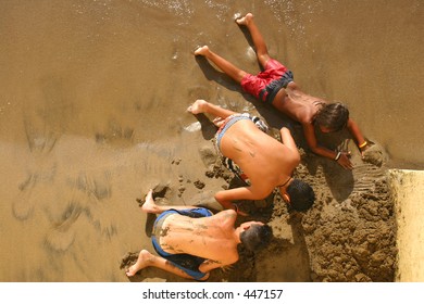 Boys Playing In The Sand From Above