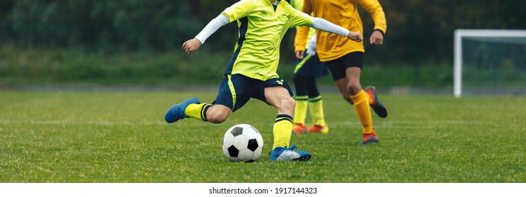 Boys Playing Sports Soccer Match. Group of Football Players Running After Ball. Football Goal in the Background