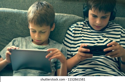 boys playing video games - Shutterstock ID 1152861581