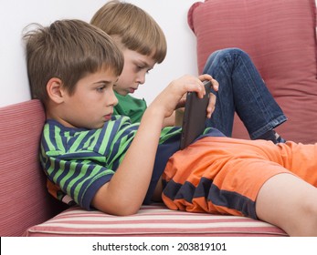 Boys Playing Video Games On The Tablet Computers