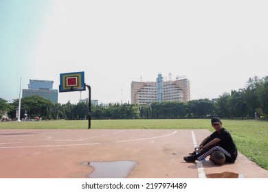 Boys Resting On The Sidelines After Playing Basketball. Playing Basketball On The Pancasila Court Simpang Lima In Semarang. Semarang, Indonesia - August 21 2022.