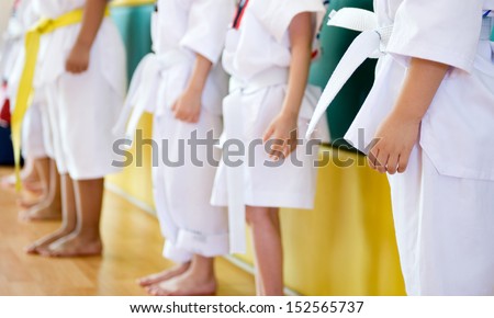 boys standing in a row, they are waitng for training exercising Taekwondo 