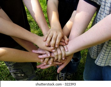 boys' team stacking hands - Powered by Shutterstock