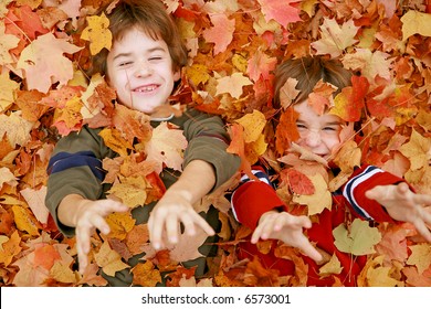 Boys Throwing Fall Leaves