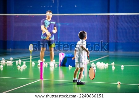 Boys training badminton indoor  activitiy