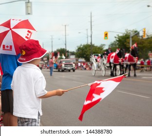 Boys Watching A Canada Day Parade. Aurora, Ontario, Canada.