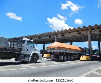 BR-101 Araquari-SC, Brazil - December 4, 2018: Trucks passing through the tollbooth on highway BR-101 Km 79,4 towards southern Brazil.