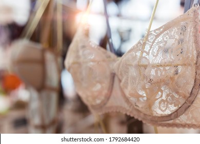 Bra in shop. Light defocused image of a lingerie store. Counter with clothes hung on it. 