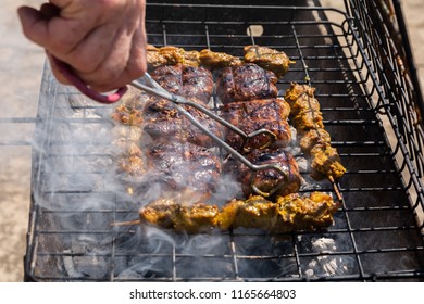 Braai Barbecue With Tongs Turning The Meat