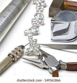 Bracelet with diamond and repairing jewelry tools (loupe,wrench,pliers,hammer)