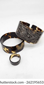 Bracelets and rings from turtle shells, one of his bracelets is decorated with beautiful silver carvings. Some people believe in turtle skin bracelets as a symbol of fertility and prosperity.