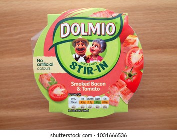 Bracknell, England - February 23, 2018: Overhead View Of A Pot Of Dolmio Stir In Pasta Sauce Photographed On A Wooden Counter Top. Dolmio Is A Brand Owned By Mars Incorporated