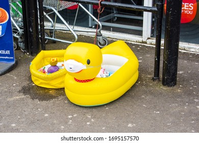 Bradford On Avon Wiltshire UK March 20 2020 An Inflatable Duck Paddling Pool With Water Toys In, And A 3M Facemask Outside A Shop At The Start Of The Corona Virus Restrictions