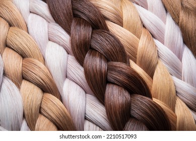 Braid of natural hair close-up. Blonde braids. Texture or background of beautiful female hair. hair coloring. hair extensions.