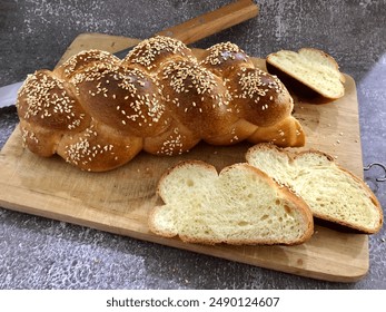 Braided challah bread slices with sesame seeds - Powered by Shutterstock