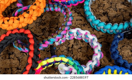 Braided paracord bracelets on a cork background. Handmade, creative design. - Powered by Shutterstock