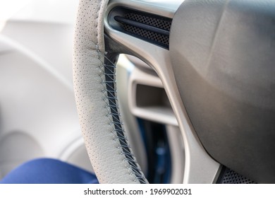 Braided Steering Wheel With Leather Cover. The Mechanic Change A New Cover Of The Steering Wheel Of The Car. Renewal Of Steering Wheel Cover.