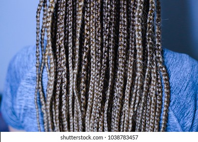 braiding of braid on the beach, beauty salons, corn rows on the girl's head, many thin braids in the African style