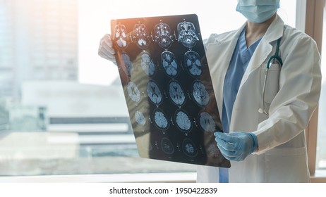 Brain Disease Diagnosis With Medical Doctor Seeing Magnetic Resonance Imaging (MRI) Film Diagnosing Elderly Ageing Patient Neurodegenerative Illness Problem For Neurological Medical Treatment