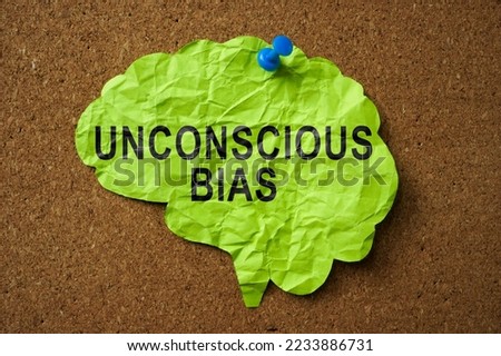 Brain made of paper with the inscription Unconscious Bias pinned to the board.