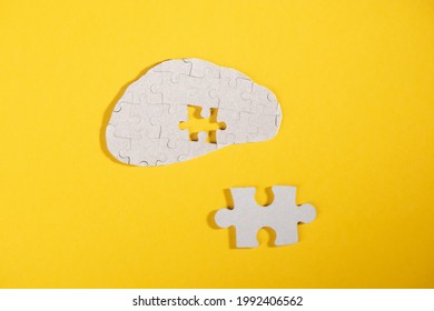 Brain made from puzzles with one missing piece and a too big puzzle which doesn't fit. Learning and complex knowledges that hard to understand.