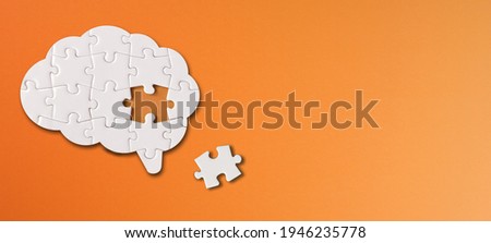 Brain shaped white jigsaw puzzle with copy space on orange background, a missing piece of the brain puzzle, mental health and problems with memory Foto stock © 