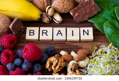 "Brain" word written od wooden blocks with foods that improve brain function, health, memory and concentration