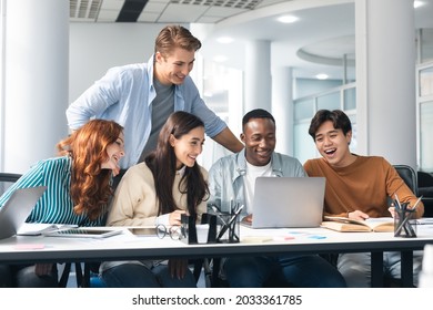 Brainstorm, Teamwork Concept. Smiling Mixed Race Employees Or Students Team Watching Webinar On Laptop Together, Working With Computer, Looking At Screen, Making Conference Video Call, Sharing Ideas