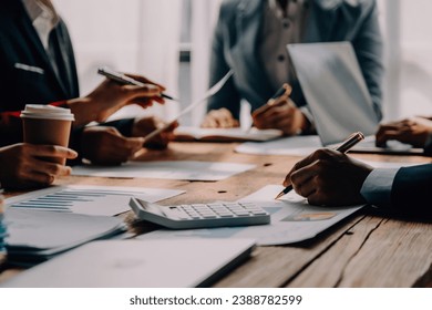 Brainstorming Collaboration and successful partnership analysis by Young business Asian people working in an office workspace - Powered by Shutterstock