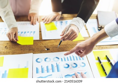 Brainstorming, Consulting, Data Analysis, Planning, Marketing and Accounting, Economist holding pen pointing to investment documents with partners on profit taking to compete with other companies.