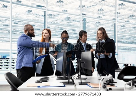 Brainstorming, microchip layout and multiethnic team in semiconductor manufacturing research facility. Optimizing PCB network topology, STEM diversity concept and multiracial coworkers using devices